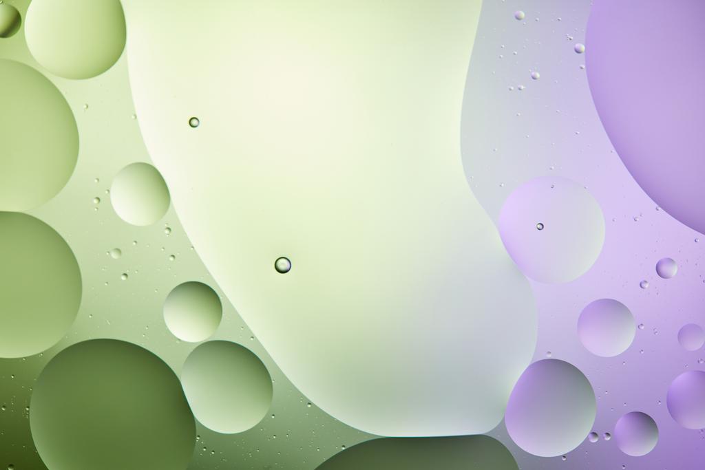 abstracte achtergrond van gemengd water en olie in licht groene en paarse kleur - Foto, afbeelding