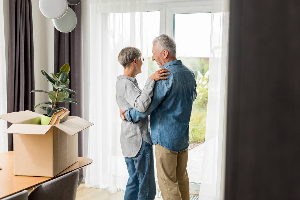 selective focus of mature man and woman dancing in new house  - Photo, Image