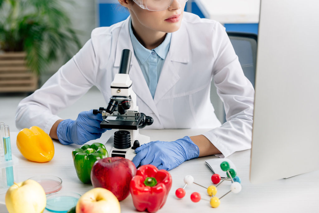 cropped view of molecular nutritionist looking at computer in lab  - Photo, Image