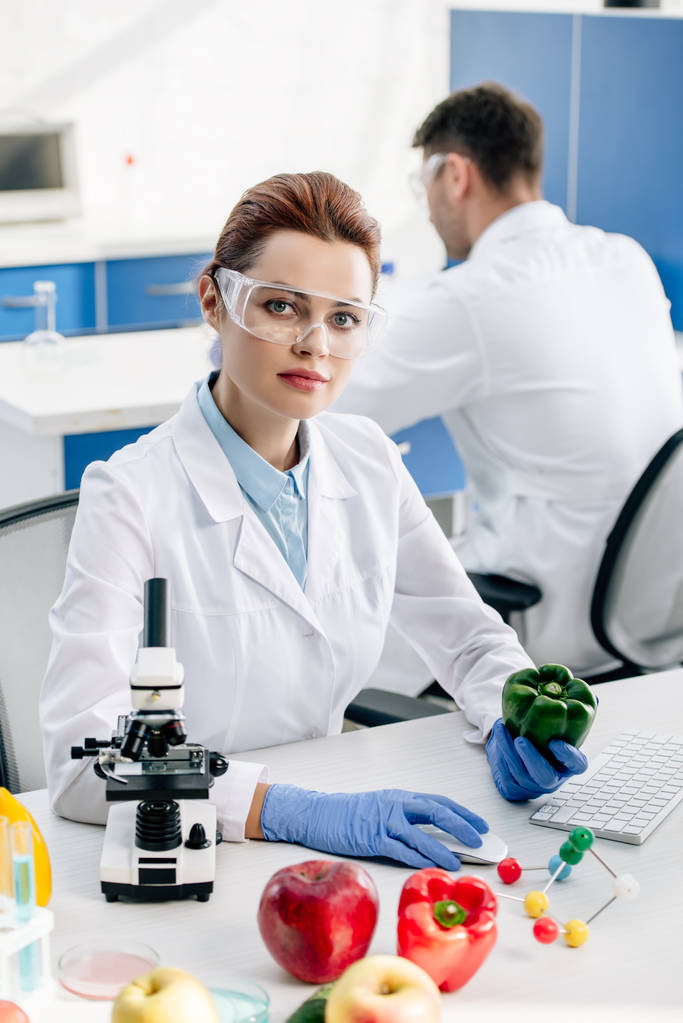 molecular nutritionist holding bell pepper and looking at camera  - Photo, Image