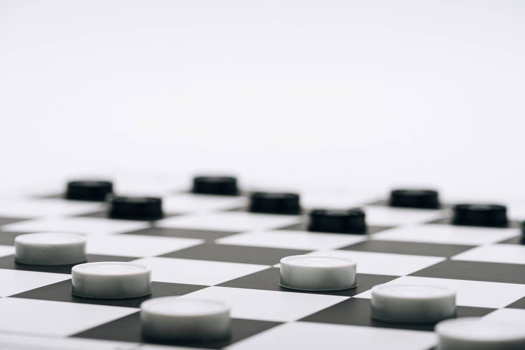 Selective focus of checkers on chessboard isolated on white - Photo, Image