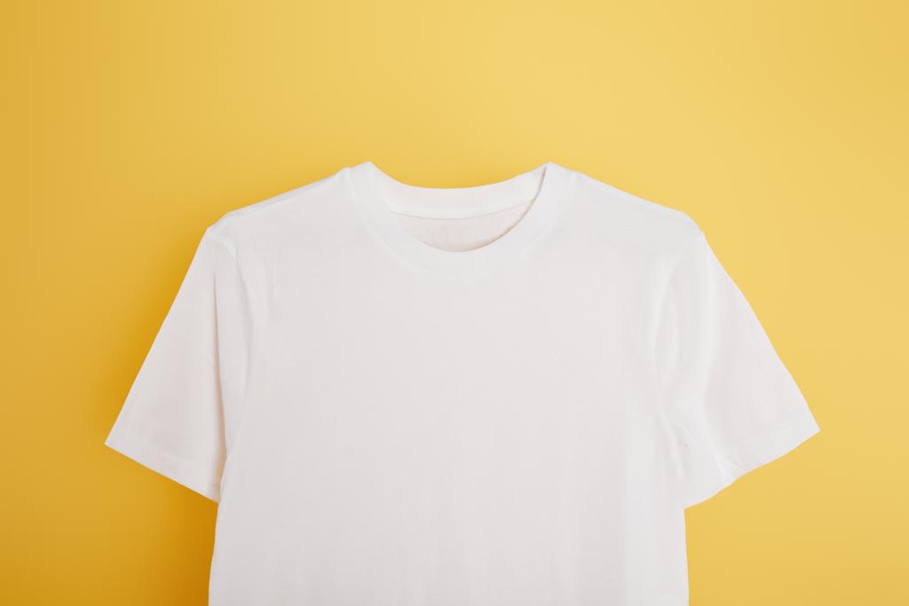 vista superior de la camiseta blanca básica sobre fondo amarillo
 - Foto, imagen