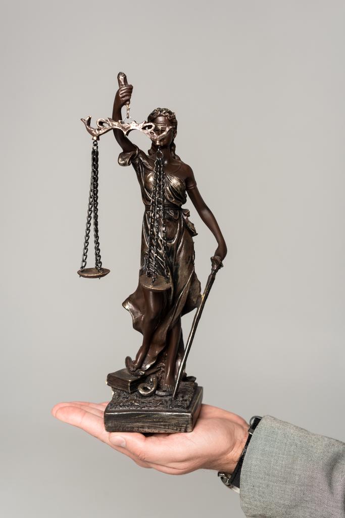 cropped view of lawyer holding themis statue isolated on grey - Photo, Image