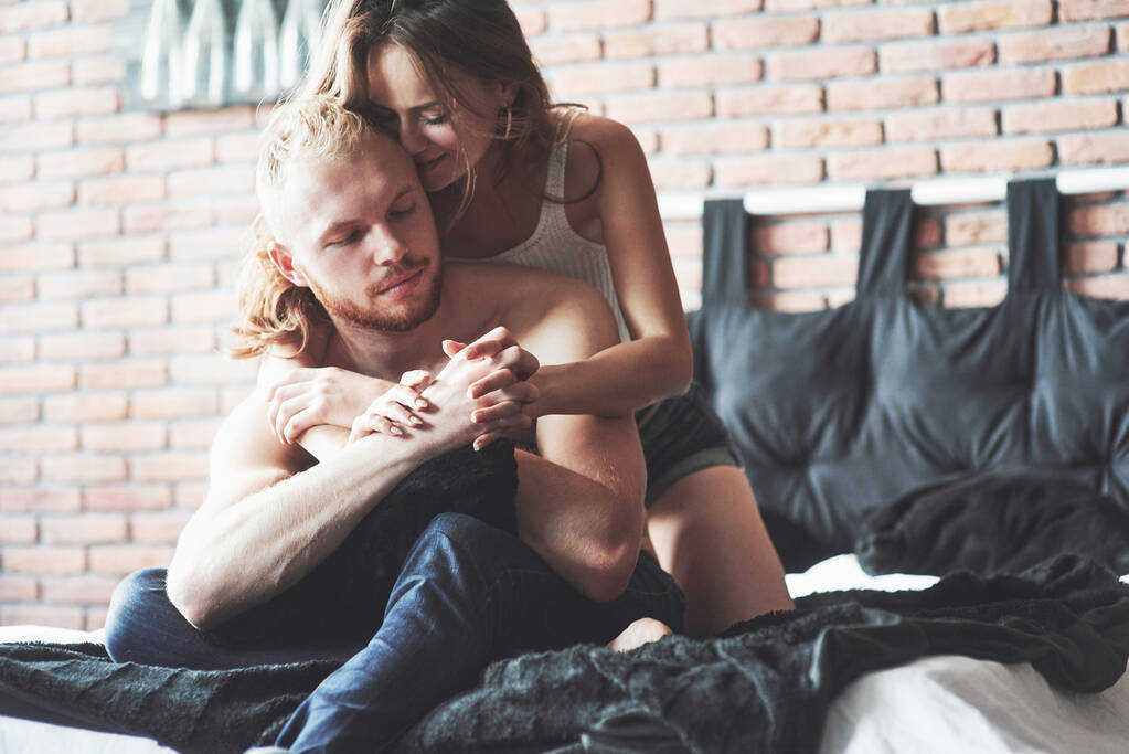 Привлекательные молодые любовники играют вместе в постели, в сексуальном белье в гостиничном номере
 - Фото, изображение