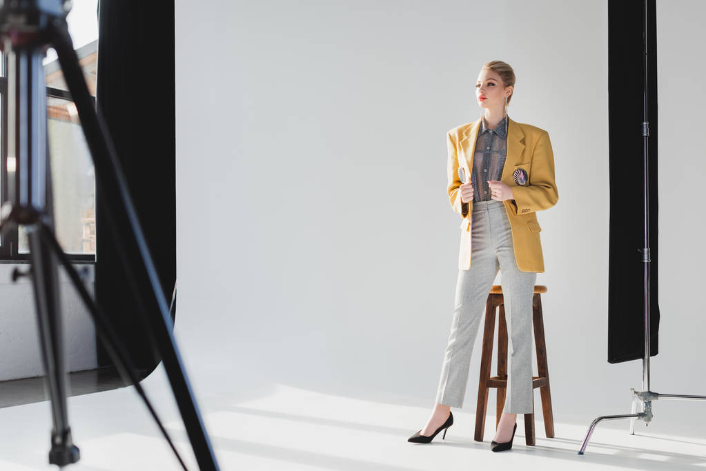 selective focus of stylish model in suit posing in photo studio - Photo, Image