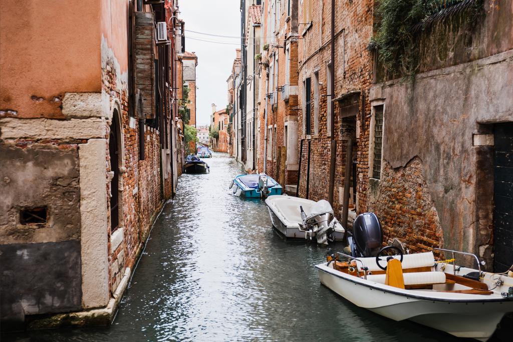 canal, motor boats near ancient buildings in Venice, Italy  - Photo, Image