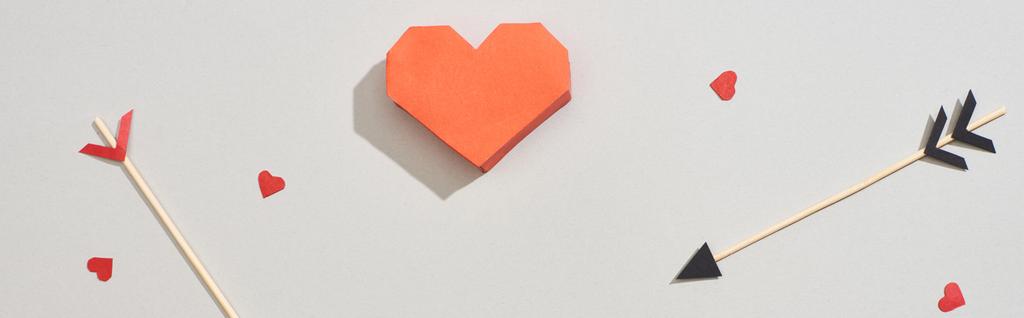 Top view of heart shaped papers with arrows on grey background, panoramic shot - Photo, Image
