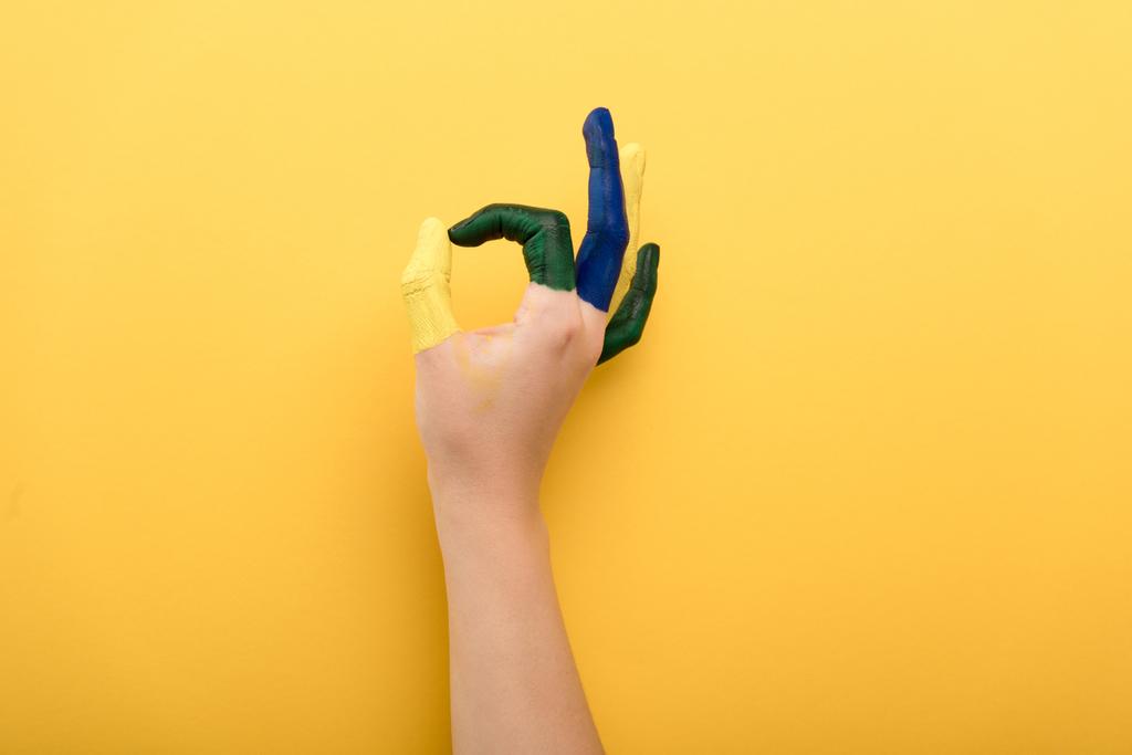 cropped view of woman with colorful fingers showing ok gesture on yellow background  - Photo, Image
