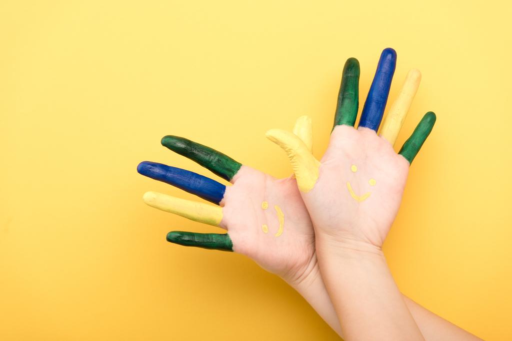 cropped view of woman with colorful fingers showing palms on yellow background  - Photo, Image