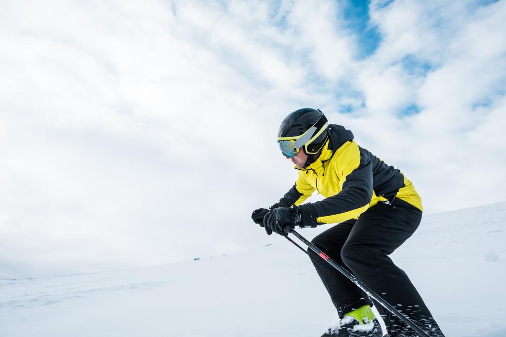 sportsman in helmet skiing on slope in wintertime  - Photo, Image