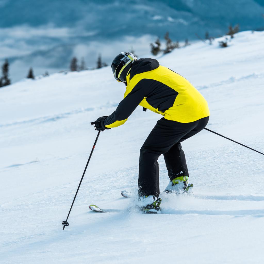 skier in helmet skiing on slope near mountains  - Photo, Image