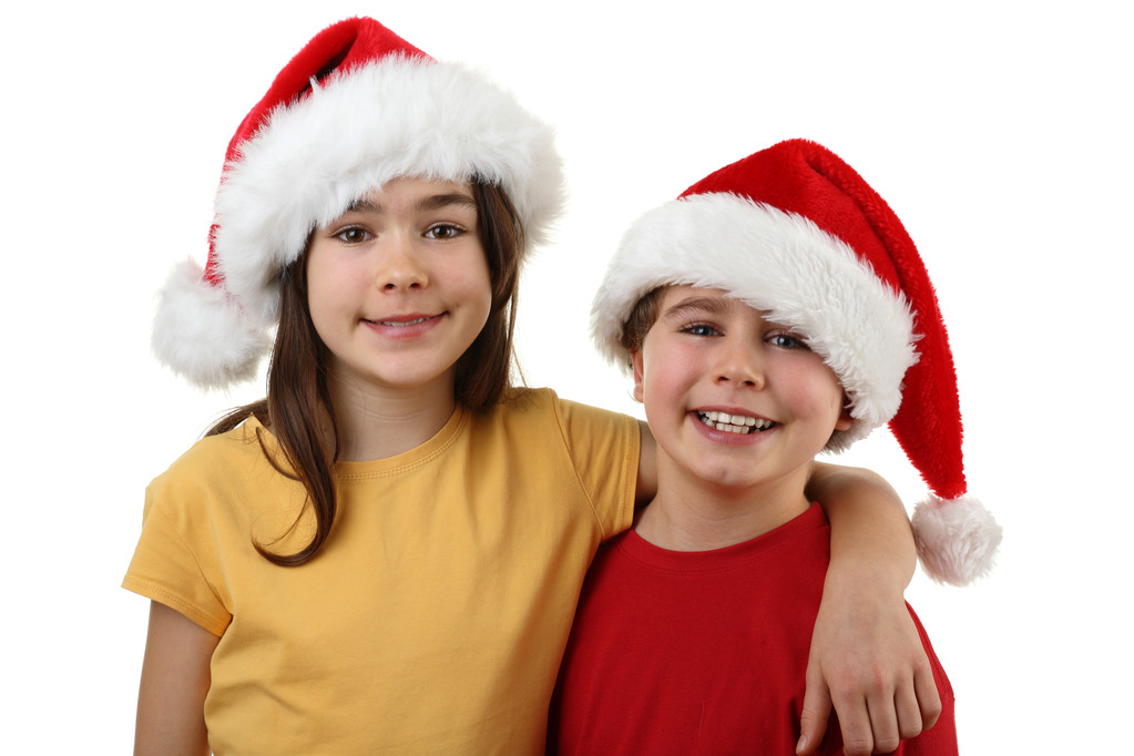 Menino e menina em chapéus de Papai Noel
 - Foto, Imagem
