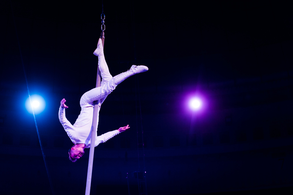 akrobata egyensúlyozó fém rúd arénában cirkusz  - Fotó, kép