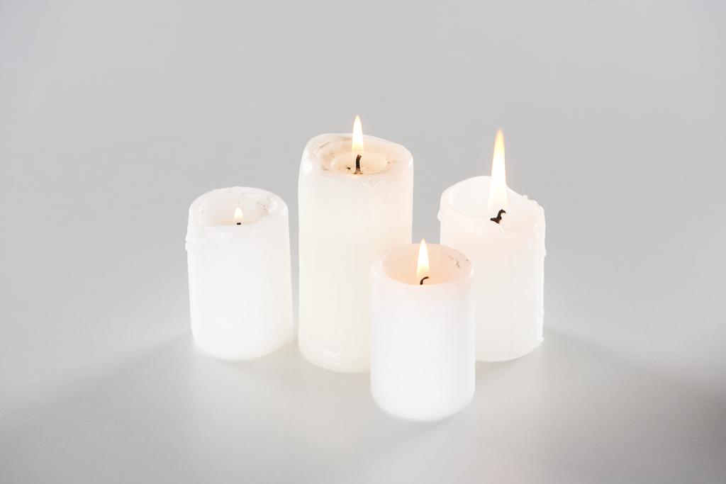 burning candles glowing on white background with shadow - Photo, Image