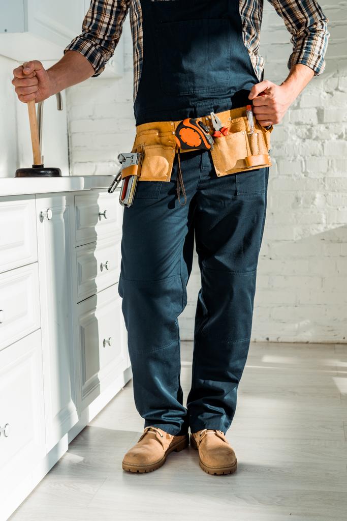 cropped view of installer standing with clenched fist and holding plumber  - Photo, Image