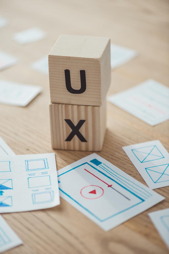 Selective focus of website template layouts and cubes with ux letters on table - Photo, Image