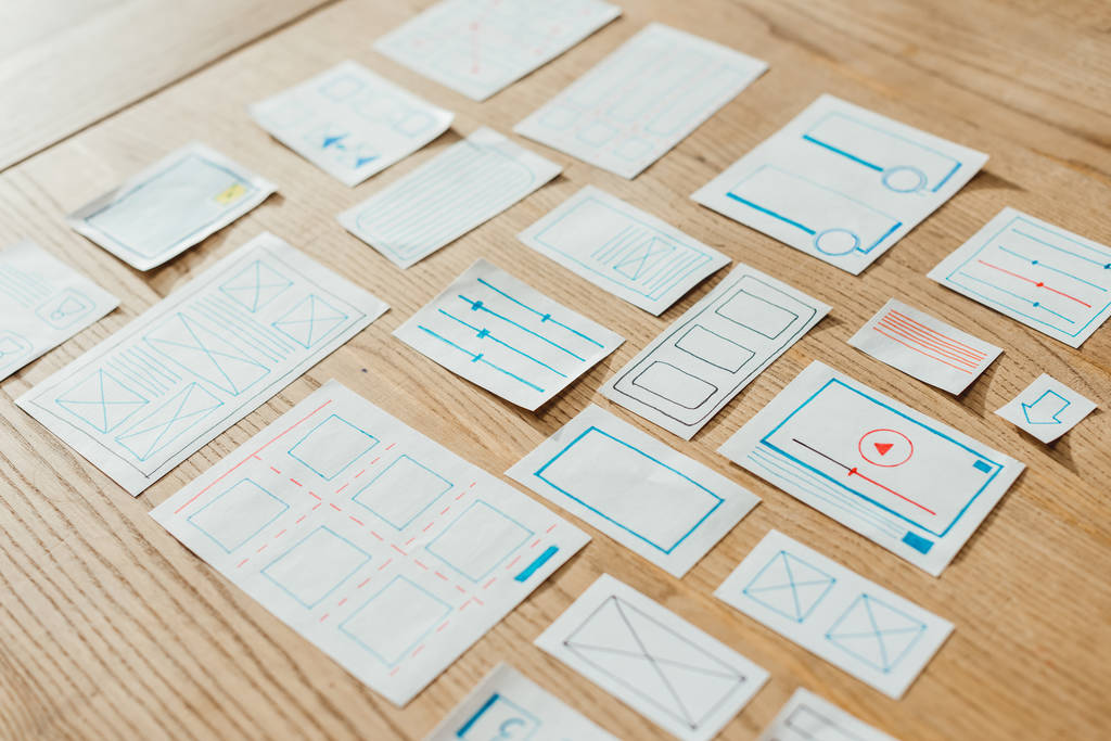 High angle view of web sketches for user experience design on wooden table - Photo, Image