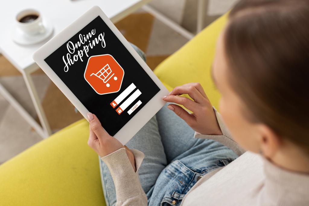 Overhead view of woman using digital tablet with online shopping lettering  - Photo, Image