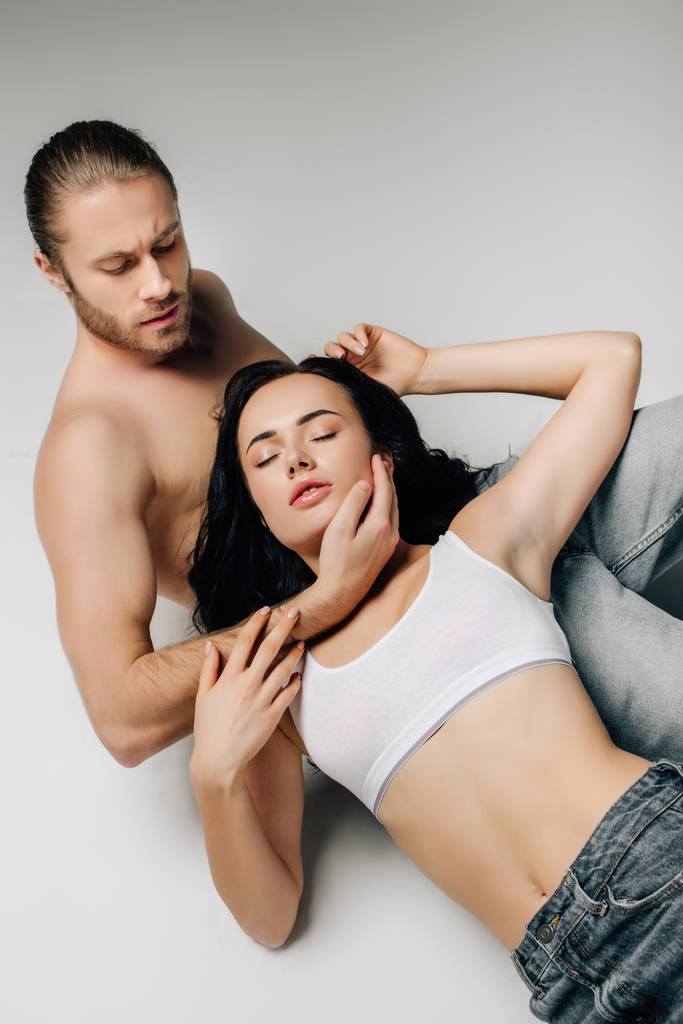 beautiful passionate couple in underwear lying on white - Photo, Image