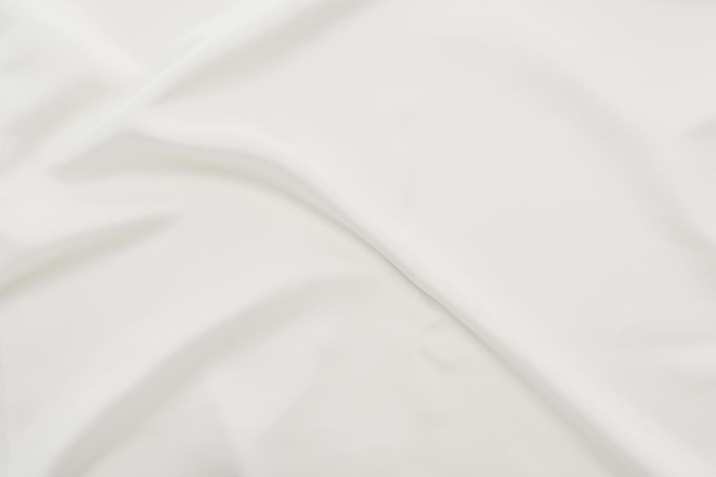Top view of wavy white cotton tablecloth - Photo, Image