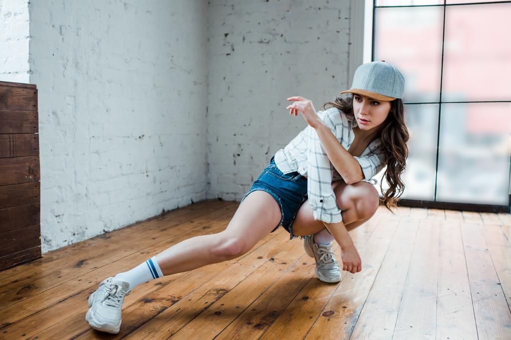 attractive dancer with crossed arms dancing hip-hop in dance studio  - Photo, Image