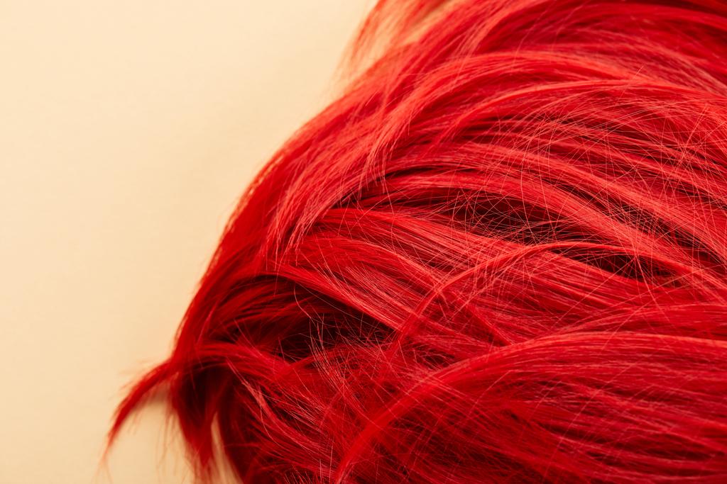 Top view of red colored hair on beige background - Photo, Image