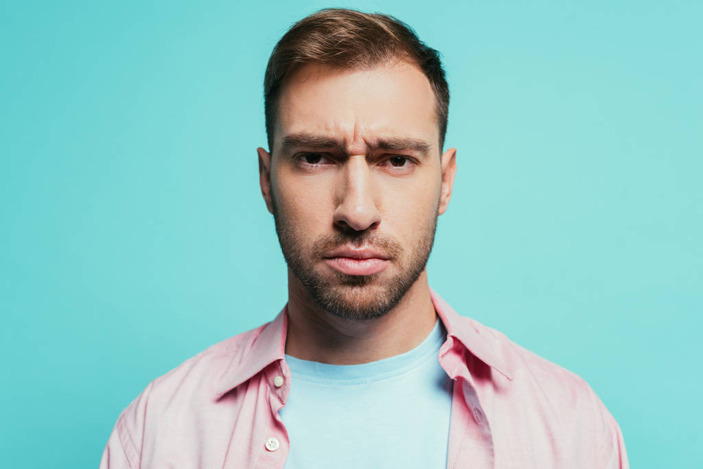 portrait of serious handsome man looking at camera, isolated on blue - Photo, Image