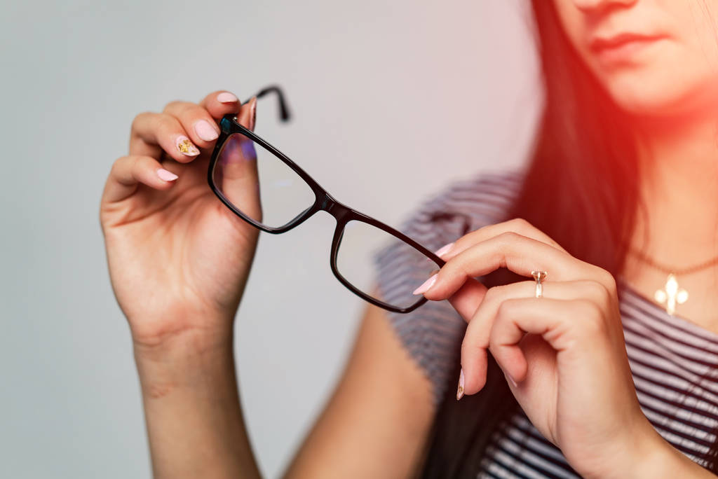 Eyeglasses closeup. Spectacles in woman's hands. Presenting glasses. Zoom in. - Photo, Image