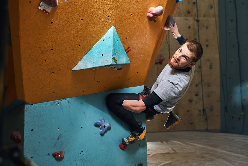 Athletic young male mountaineer trains hard despite his physical disability - Photo, Image