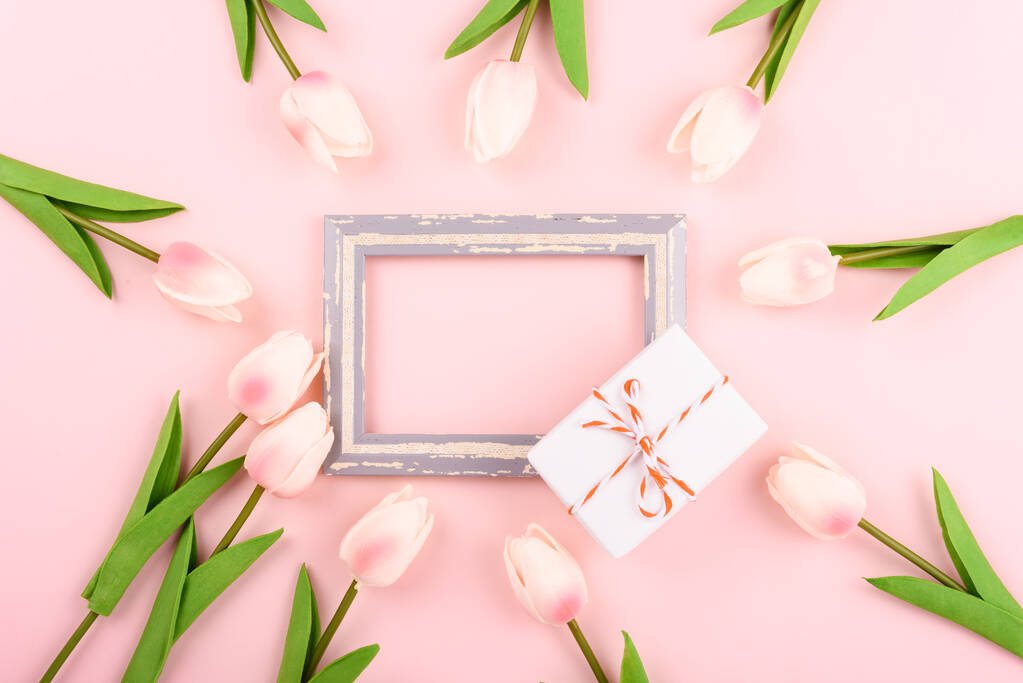 Happy Women's Day, Mother's Day concept. top view flat lay photo frame, gift box and Tulip flower on pink background, copy space for your text - Photo, Image