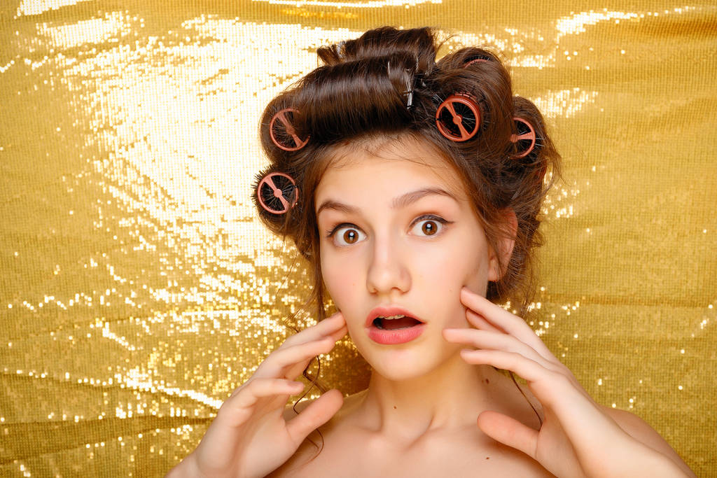 Altın izole saç curlers içinde güzel kız - Fotoğraf, Görsel