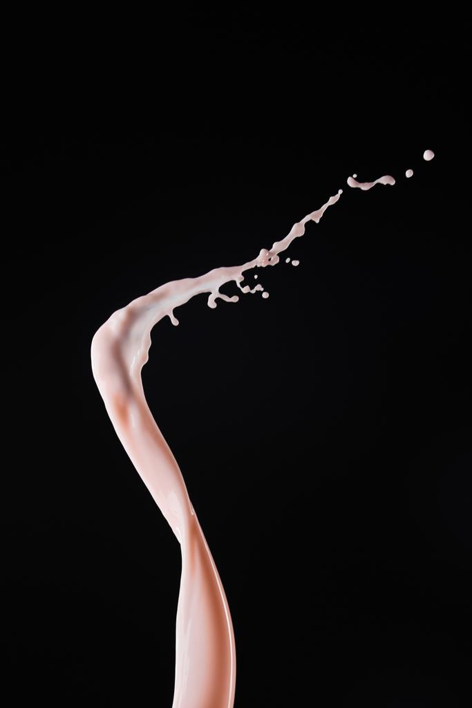 smooth fresh pink milk splash with drops isolated on black - Photo, Image
