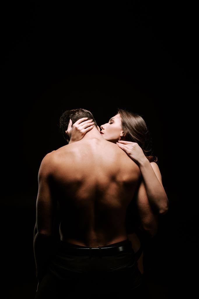 seductive woman hugging sexy man isolated on black  - Photo, Image