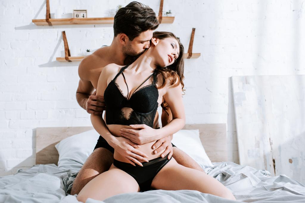 сексуальный мужчина без рубашки целует соблазнительную девушку в спальне
  - Фото, изображение