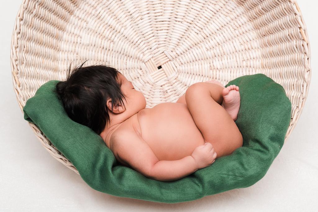 adorable newborn mixed race baby sleeping in basket on white - 写真・画像