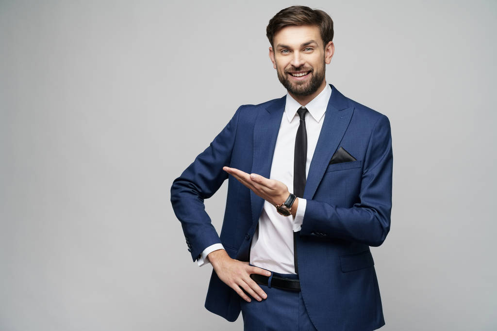 Portrait of a young businessman pointing on a copyspace with his finger - Photo, Image