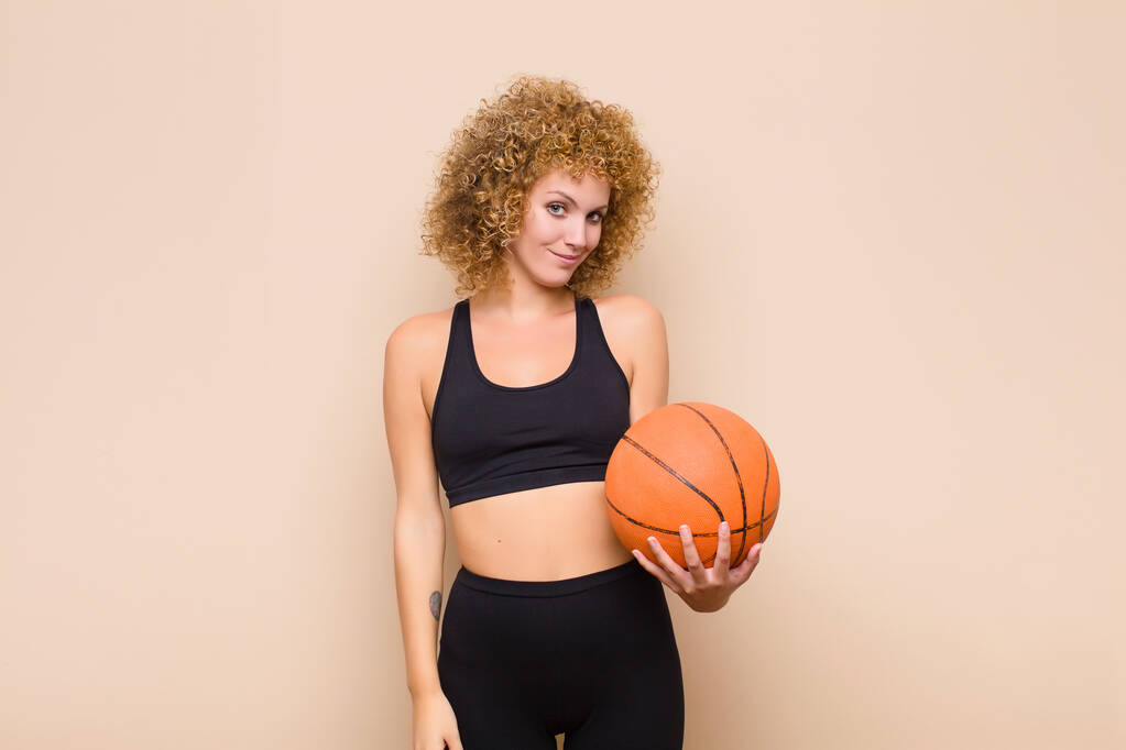 young afro woman looking proud, confident, cool, cheeky and arrogant, smiling, feeling successful sport concept - Photo, Image