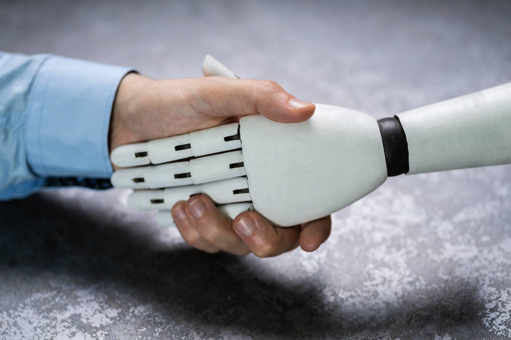 Κοντινό πλάνο του Digital Generated Human Hand and Business Man Shaking Hands Against Grey Background - Φωτογραφία, εικόνα