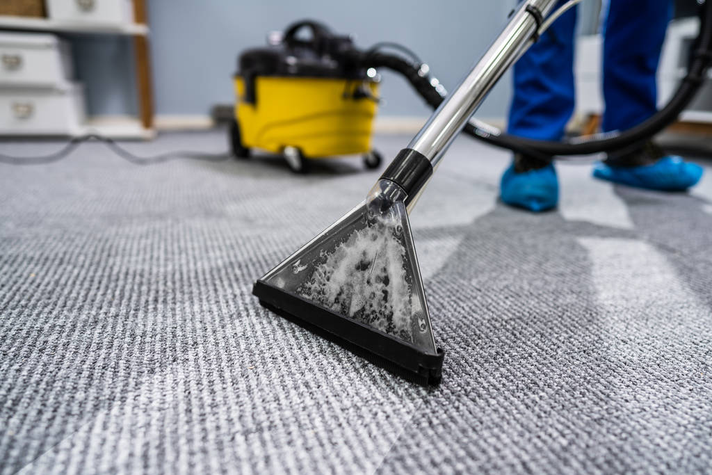 Photo Of Janitor Cleaning Carpet With Vacuum Cleaner - Photo, Image