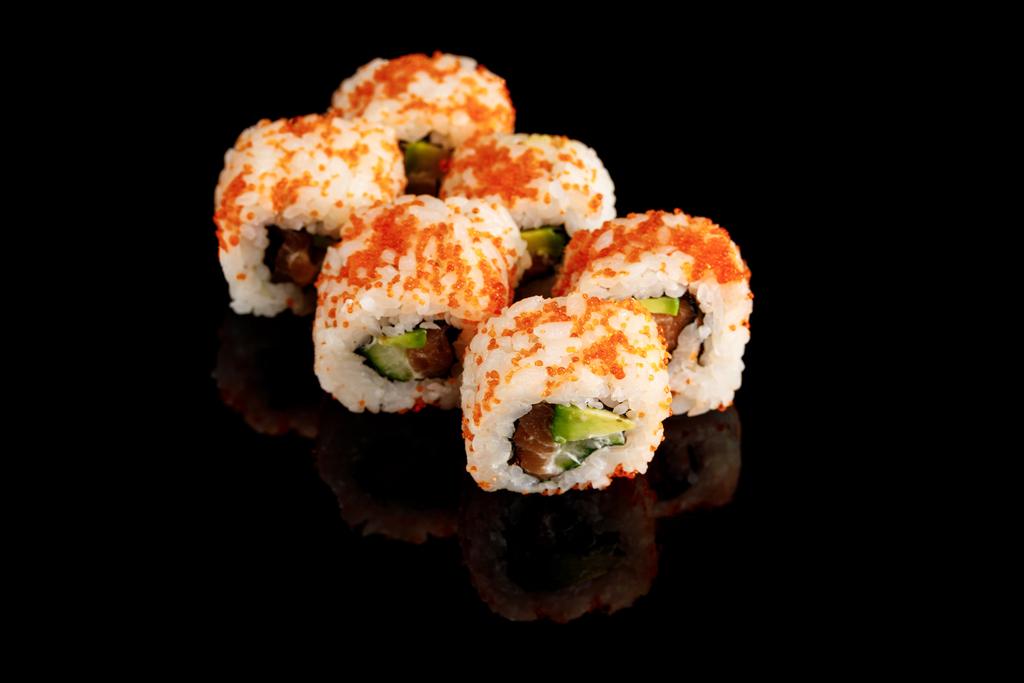 delicious California roll with avocado, salmon and masago caviar isolated on black - Photo, Image