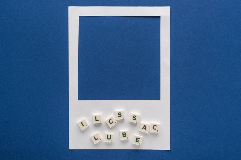 vue du haut des lettres sur cubes et cadre photo blanc sur fond bleu
 - Photo, image