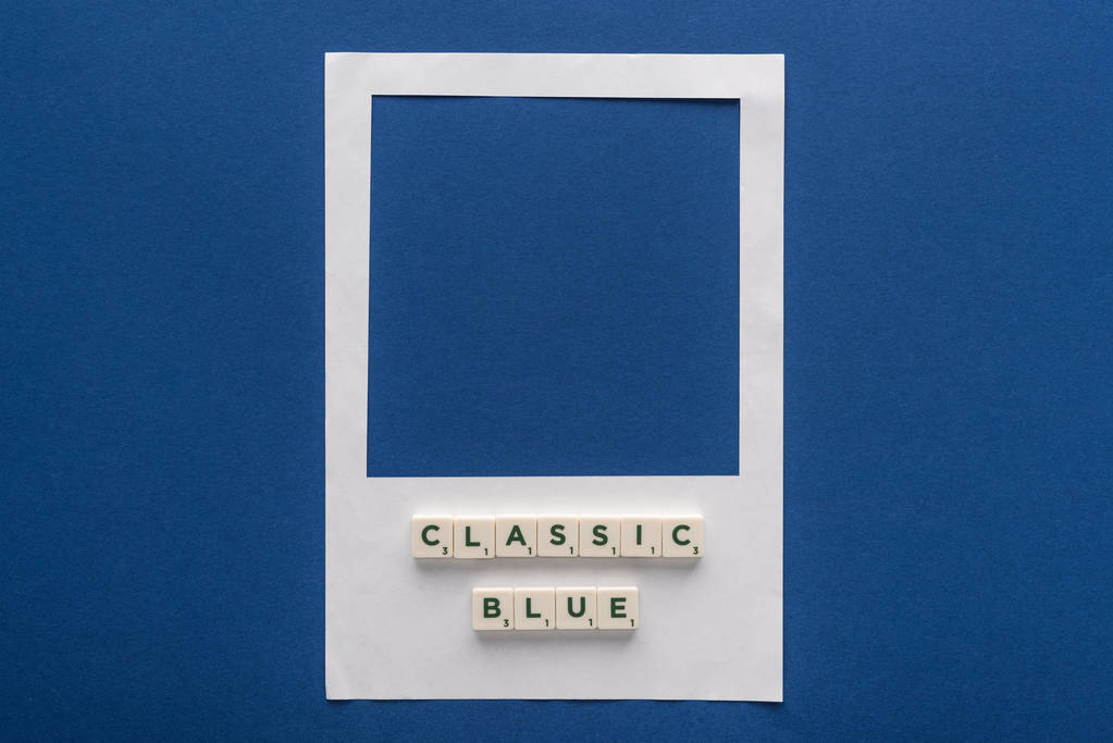 top view of classic blue lettering on cubes on white photo frame on blue background - Photo, Image