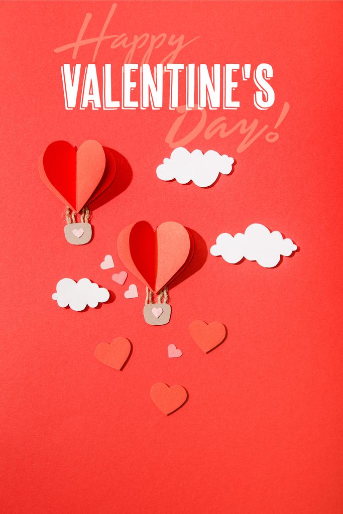 top view of paper heart shaped air balloons in clouds near happy valentines day lettering on red background - Photo, Image