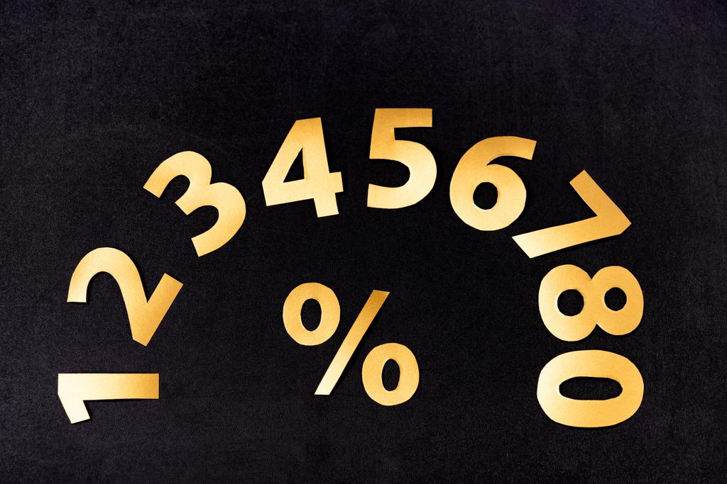 top view of golden numbers and percent sign on black background - Photo, Image