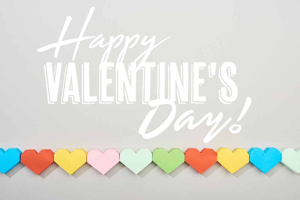 Top view of decorative papers in heart shape on grey background with happy valentines day illustration  - Photo, Image