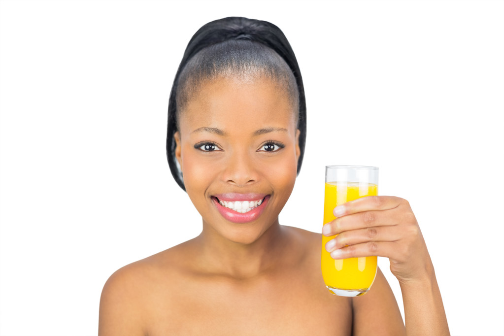 Smiling woman holding glass orange juice - Photo, Image