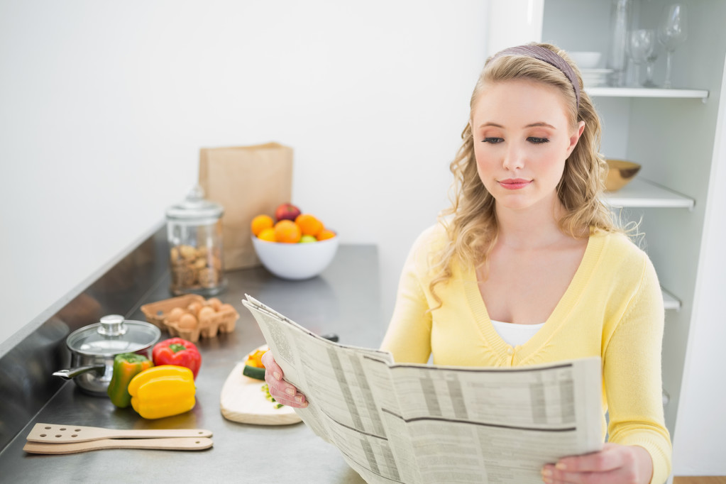 Content cute blonde reading newspaper - Photo, Image