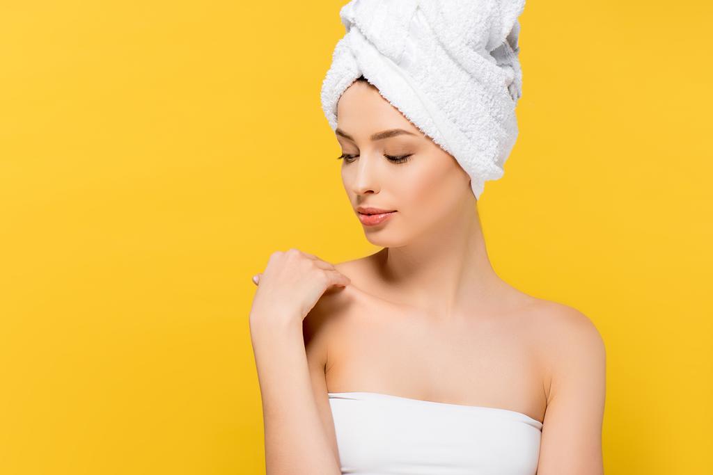attractive girl with towel on head, isolated on yellow - Photo, Image