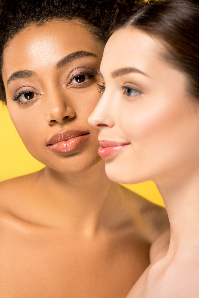 portrait of naked multicultural girls with perfect skin, isolated on yellow - 写真・画像