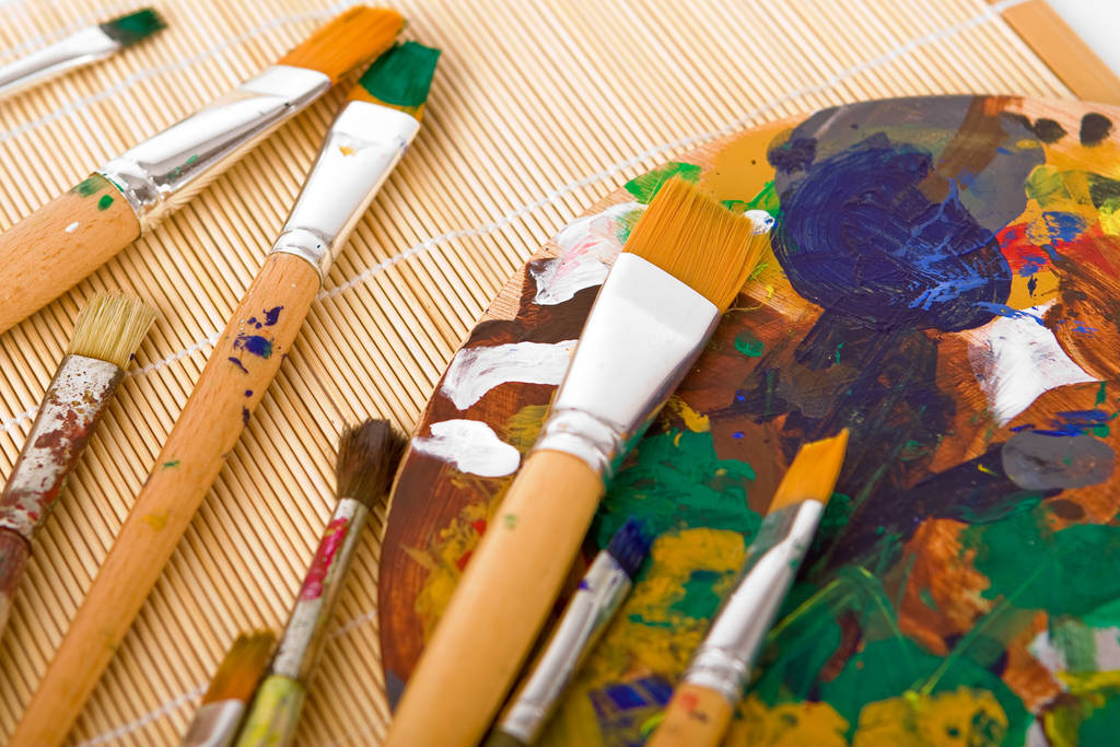 paint brushes and paints on the table - Photo, Image